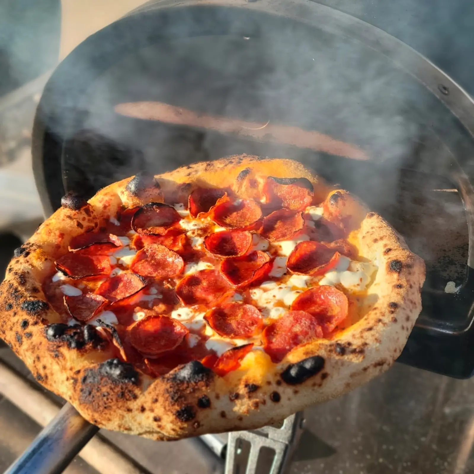 Pepperoni pizza cooking inside a REDs Pizza oven