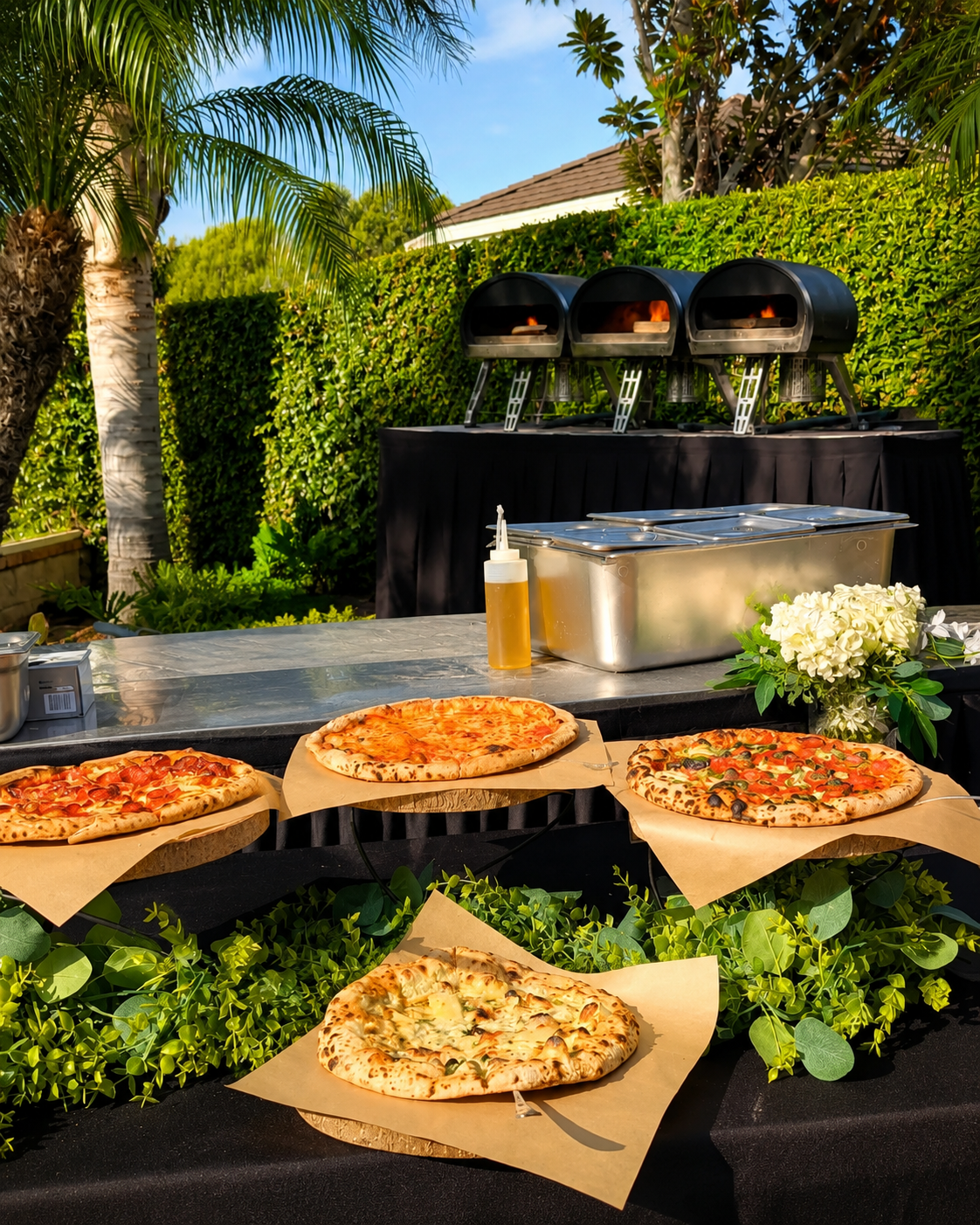 REDs Pizza live catering setup with ovens and buffet display